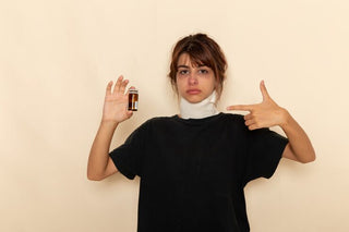 Woman holding tincture bottle