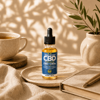 Innovative CBD Professional CBD + CBDa berry oil bottle styled in a warm editorial wellness scene with soft natural sunlight, ceramic decor, and premium neutral tones.
