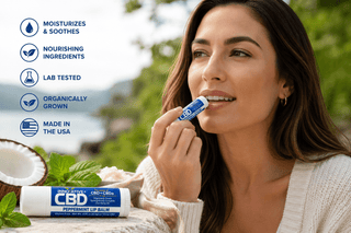 Woman applying Innovative CBD Peppermint Lip Balm outdoors with natural mint and coconut ingredients, showcasing soothing daily lip hydration and wellness support.