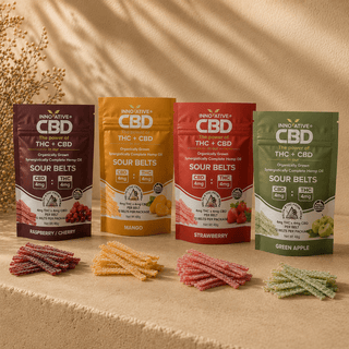 Innovative CBD full spectrum THC and CBD sour belts flavor collection featuring strawberry, mango, green apple, and raspberry cherry pouches with sugar-coated ribbon-style sour belts in a premium editorial product scene.